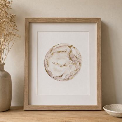 Framed watercolour embryo artwork on a wall with a vase and bowl in the foreground.