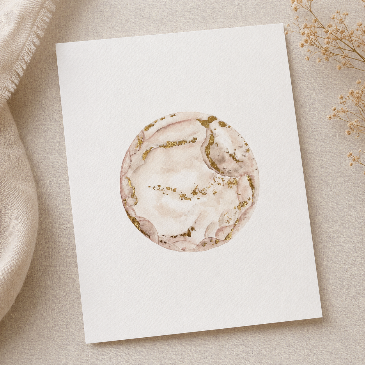 Watercolour embryo painting with a circular marble design on a beige surface