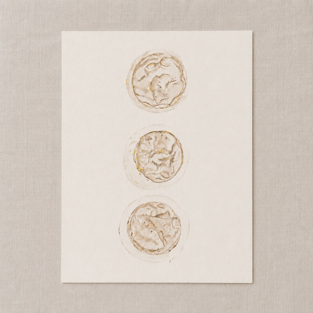 Watercolour painting of 3 embryos on a white card against a beige background